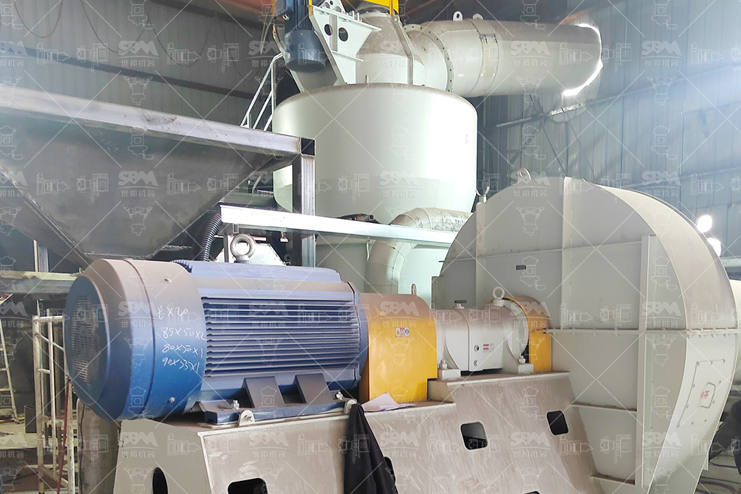 Gypsum powder being mixed into fertilizer blend
