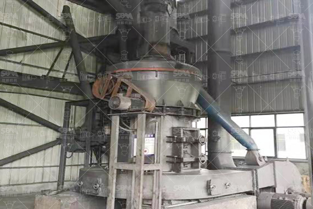 Raw magnesite ore being fed into a grinding mill for 300 mesh powder production